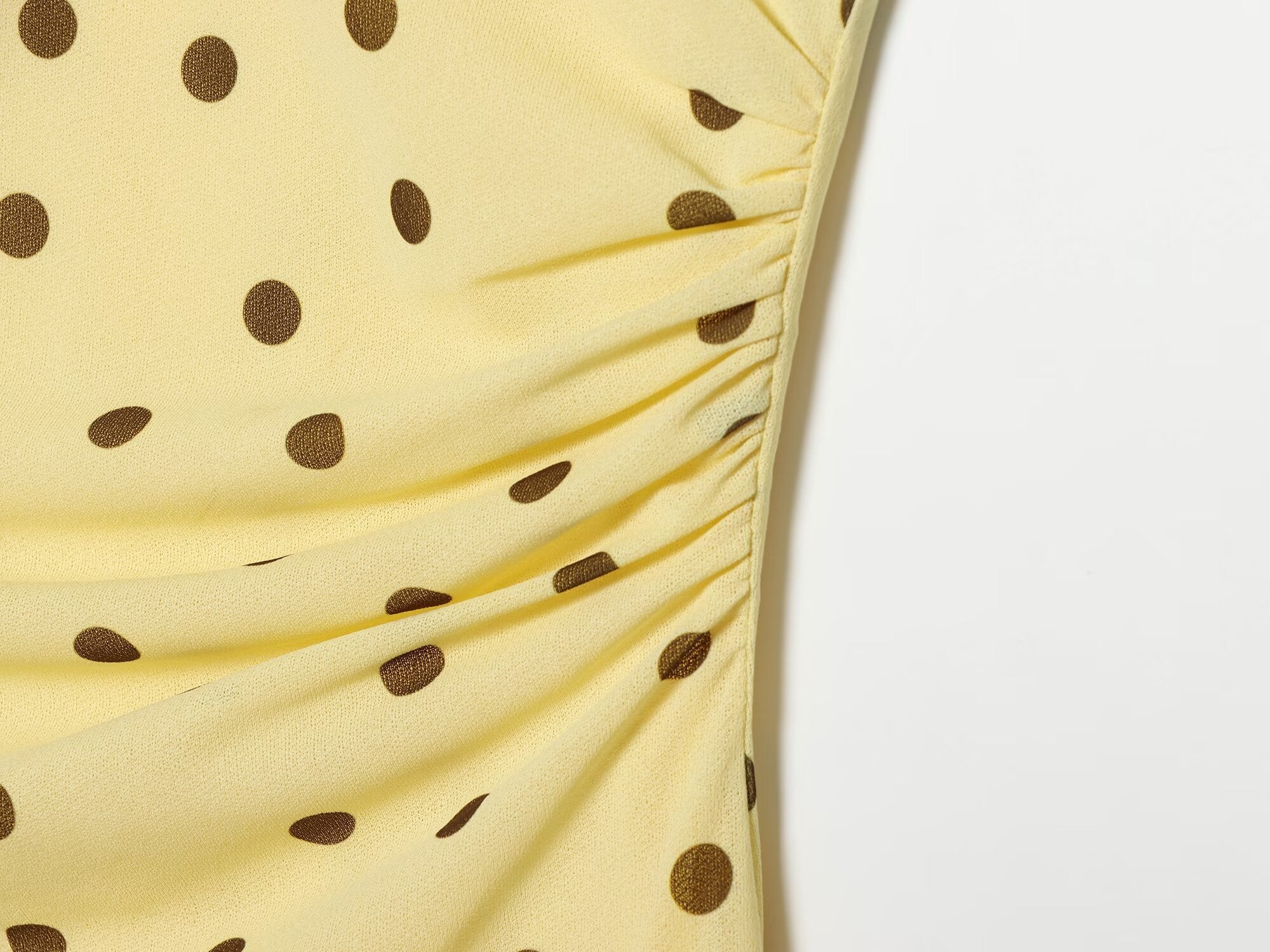 Women's sleeveless polka dot draped dress